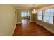 Comfortable dining room featuring hardwood floors, a chandelier, and open access to other rooms at 1609 Cypress Dr, Henderson, NC 27536