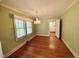 Inviting dining room featuring hardwood floors, a chandelier, and a window with natural light at 1609 Cypress Dr, Henderson, NC 27536