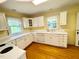 Bright kitchen featuring white cabinets, ample counter space, and a window with natural light at 1609 Cypress Dr, Henderson, NC 27536