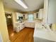 Functional kitchen featuring white cabinets, ample counter space, and hardwood floors at 1609 Cypress Dr, Henderson, NC 27536
