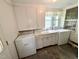 Laundry room featuring washer, dryer, sink, and cabinetry at 1609 Cypress Dr, Henderson, NC 27536