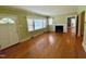 Bright living room features hardwood floors, large windows, and a fireplace with a white mantel at 1609 Cypress Dr, Henderson, NC 27536