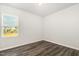 Bedroom with wood flooring and a window overlooking an outdoor view at 1725 Winter Jasmine Ln, Wake Forest, NC 27587