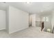 A bonus room features neutral carpet and walls, and a stair case with a window at 1725 Winter Jasmine Ln, Wake Forest, NC 27587