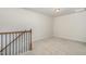 A bonus room features neutral carpet and walls, and a stair case at 1725 Winter Jasmine Ln, Wake Forest, NC 27587