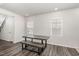 Well-lit dining area featuring a modern table with bench seating and wood-look floors at 1725 Winter Jasmine Ln, Wake Forest, NC 27587