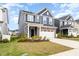 Beautiful new construction home with lush green lawn and a two-car garage at 1725 Winter Jasmine Ln, Wake Forest, NC 27587