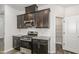 Modern kitchen features stainless steel appliances, granite countertops, and sleek, dark cabinetry at 1725 Winter Jasmine Ln, Wake Forest, NC 27587