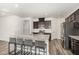 Modern kitchen with granite countertops, stainless steel appliances, and a large island with seating at 1725 Winter Jasmine Ln, Wake Forest, NC 27587