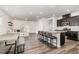 Modern kitchen features a large island with seating, stainless steel appliances, and hardwood floors at 1725 Winter Jasmine Ln, Wake Forest, NC 27587
