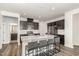 Modern kitchen with granite countertops, stainless steel appliances, and an island with bar stool seating at 1725 Winter Jasmine Ln, Wake Forest, NC 27587