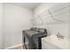 The laundry room features a utility sink, washer, dryer, and convenient wire shelving at 1725 Winter Jasmine Ln, Wake Forest, NC 27587