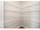 Walk-in pantry features white wire shelving to maximize storage space at 1725 Winter Jasmine Ln, Wake Forest, NC 27587