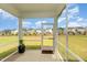 Screened-in patio with a view of the backyard and surrounding neighborhood at 1725 Winter Jasmine Ln, Wake Forest, NC 27587