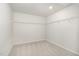 A walk-in closet features neutral carpet and walls, and shelving at 1725 Winter Jasmine Ln, Wake Forest, NC 27587
