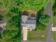 Aerial view of a quaint single-Gathering home nestled amongst mature trees, featuring a classic roof at 188 Worthington Ct, Clayton, NC 27527