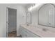 Bathroom featuring double sink vanity with lots of storage and a large mirror at 188 Worthington Ct, Clayton, NC 27527