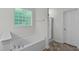 Bright bathroom with a soaking tub and glass enclosed shower at 188 Worthington Ct, Clayton, NC 27527