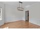 Formal dining room featuring hardwood floors, decorative molding, and a modern light fixture at 188 Worthington Ct, Clayton, NC 27527