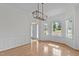 Bright dining room boasts hardwood floors, decorative molding, contemporary lighting and large windows at 188 Worthington Ct, Clayton, NC 27527