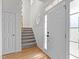 Inviting entryway features hardwood floors, staircase, and a front door with sidelight windows at 188 Worthington Ct, Clayton, NC 27527