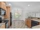 Eat-in kitchen features granite countertops, wooden cabinets, and modern appliances at 188 Worthington Ct, Clayton, NC 27527