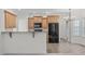 Well-lit kitchen featuring granite countertops, wooden cabinets, and stainless-steel appliances at 188 Worthington Ct, Clayton, NC 27527