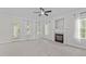 Spacious living room with a cozy fireplace, neutral carpet, and multiple windows for natural light at 188 Worthington Ct, Clayton, NC 27527