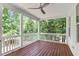 Relaxing screened-in porch with stained wood floors and a ceiling fan at 188 Worthington Ct, Clayton, NC 27527