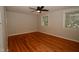 This bedroom features hardwood floors, neutral paint, and a modern ceiling fan with great natural light at 1908 Smallwood Dr, Raleigh, NC 27605