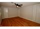 This bedroom features hardwood floors, neutral paint, a ceiling fan, and two closets at 1908 Smallwood Dr, Raleigh, NC 27605