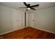 This bedroom features hardwood floors, neutral paint, a ceiling fan, and a closet at 1908 Smallwood Dr, Raleigh, NC 27605