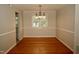 Dining area features hardwood floors, neutral walls, and a chandelier, creating an inviting atmosphere at 1908 Smallwood Dr, Raleigh, NC 27605