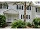 Charming townhouse with black shutters, complemented by lush landscaping, offering inviting curb appeal at 1908 Smallwood Dr, Raleigh, NC 27605