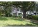 Charming home with large trees, a well manicured lawn, and a welcoming front entrance at 1908 Smallwood Dr, Raleigh, NC 27605