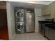 Compact kitchen featuring stainless steel appliances, including stackable washer/dryer for modern convenience at 1908 Smallwood Dr, Raleigh, NC 27605