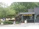 An outdoor seating area with umbrellas in front of the Postino restaurant at 1908 Smallwood Dr, Raleigh, NC 27605