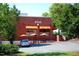 The exterior of Rise restaurant with outdoor tables and chairs and parking in the front at 1908 Smallwood Dr, Raleigh, NC 27605