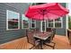 Outdoor deck with table and chairs shaded by a umbrella for relaxing and entertaining at 2100 Della Ct, Apex, NC 27502