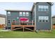 The house has a wooden deck for outdoor enjoyment, alongside a neat patio and green lawn at 2100 Della Ct, Apex, NC 27502