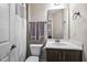 Cozy bathroom features a shower, toilet, and sink with a vanity with great lighting and neutral color palette at 2100 Della Ct, Apex, NC 27502