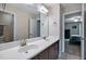 This bathroom boasts double sinks with modern fixtures, a large mirror, and a neutral color scheme at 2100 Della Ct, Apex, NC 27502