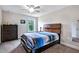 Bedroom featuring a wooden bed frame, carpet flooring, neutral walls, and large chest of drawers at 2100 Della Ct, Apex, NC 27502