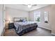 Cozy bedroom with carpet flooring, neutral walls, a window, and a comfortable-looking bed at 2100 Della Ct, Apex, NC 27502