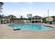 Large community pool with ample seating and a covered lounge area for residents to enjoy at 2100 Della Ct, Apex, NC 27502