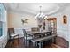Elegant dining room with a modern chandelier, stylish furniture, and hardwood floors at 2100 Della Ct, Apex, NC 27502