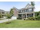 Charming brick home with a well-maintained lawn, inviting front porch, and lush landscaping at 2100 Della Ct, Apex, NC 27502