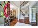 Grand foyer showcasing hardwood floors, a staircase, and a view into the dining room at 2100 Della Ct, Apex, NC 27502