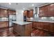 Gourmet kitchen with stainless steel appliances, granite countertops, and a large center island at 2100 Della Ct, Apex, NC 27502
