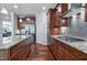 A gourmet kitchen is showcased with custom cabinets, granite counters and stainless steel appliances at 2100 Della Ct, Apex, NC 27502